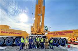 McNally Nimergood team lined up in front of a crane